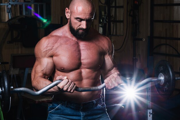 Bearded man looking at barbell