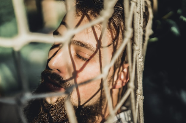 bearded man lying hammock on a warm summer day