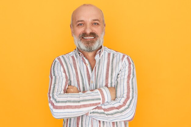 Free Photo Middle Aged Bald Man In Suit Holding Laptop Looking At Front With Smile On Smart Face Showing Thumb Up Standing Over Purple Wall