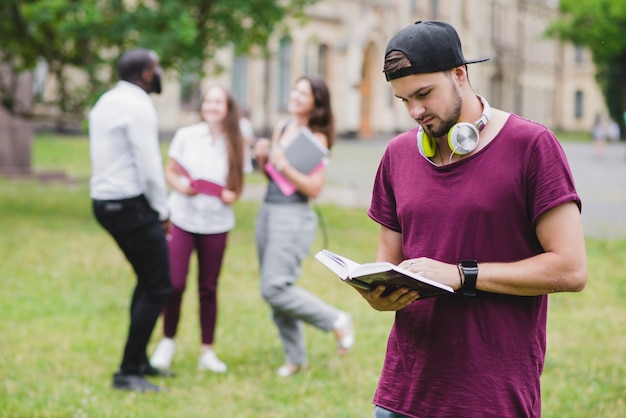 Free photo bearded man reading book standing