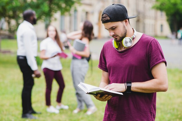 bearded man reading book standing