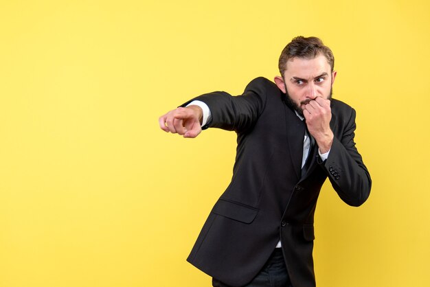 Bearded man showing the direction with serious facial expression