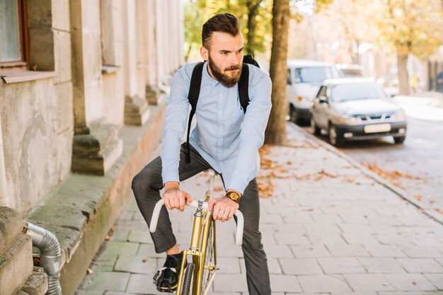 Bearded man sitting on bicycle