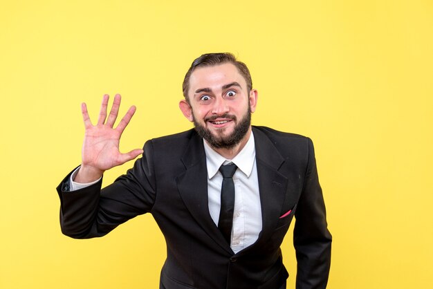 Bearded man in suit making bye gesture