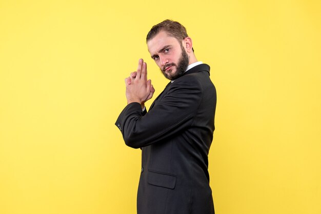 Bearded man in suit showing finger gun