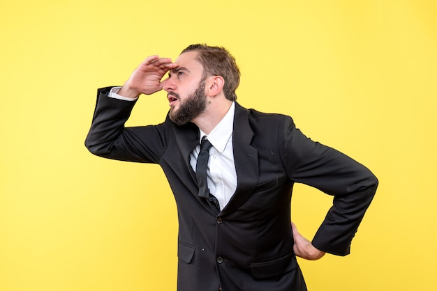 Bearded man thinking one hand on his forehead and the other is on his back