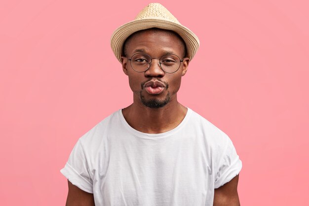 Bearded man in white T-shirt and straw hat