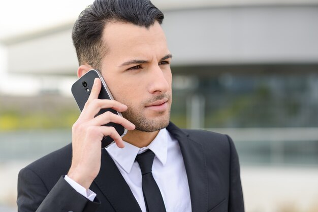 Bearded manager with his mobile phone