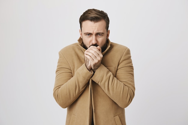 Free photo bearded middle-aged man feeling cold on street