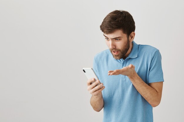 Bearded portrait of a young guy with blue Tshirt