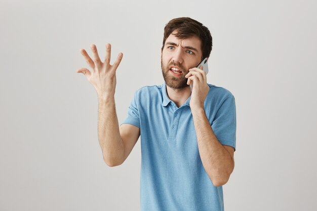 bearded portrait of a young guy with blue tshirt