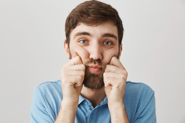 Bearded portrait of a young guy with blue Tshirt