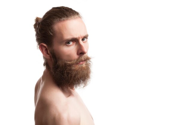 Bearded tattooed hipster on white background in studio photo