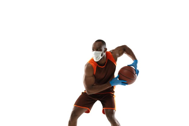 Beat it off. African-american basketball player in protective mask.