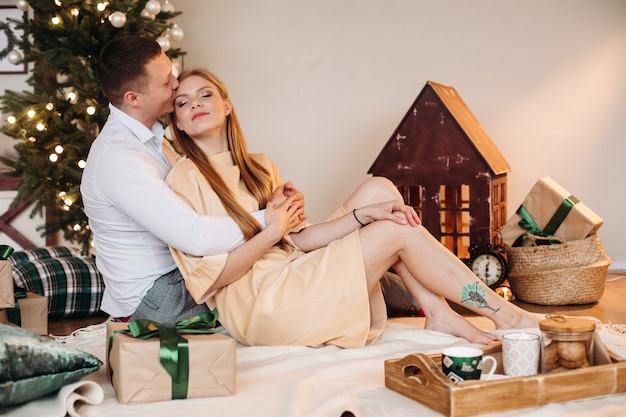 Beautfiul woman with fair red hair hugs with her caucasian boyfriend and relaxes