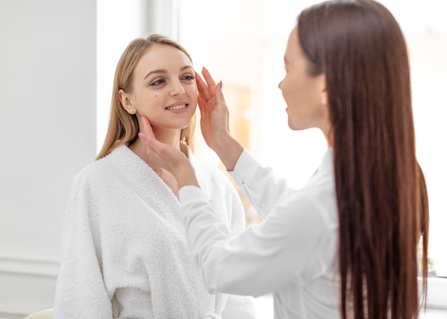 Beautician woman at clinic consults client