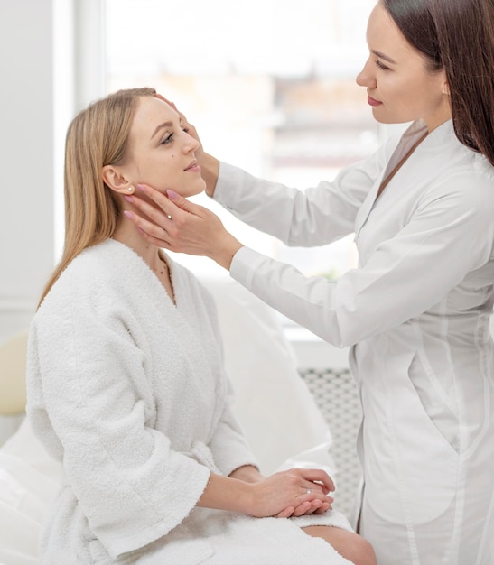 Beautician woman at clinic consults client