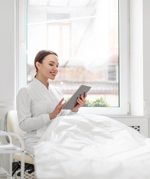 beautician woman at clinic with tablet