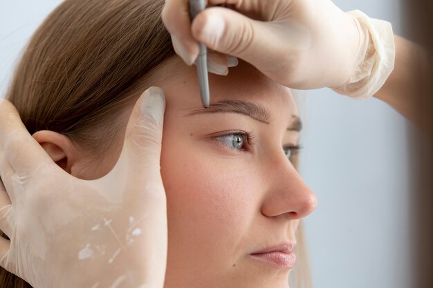 Beautician working on a client's eyebrows