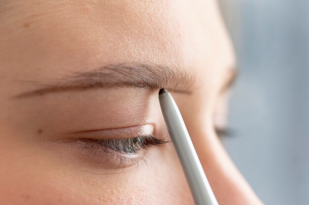 Beautician working on a client's eyebrows