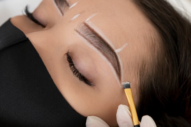 Beautician working on a client's eyebrows