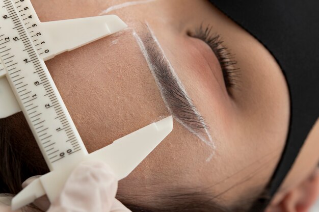 Beautician working on a client's eyebrows