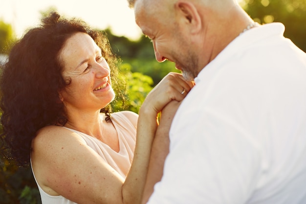 Beautiful adult couple spend time in a summer field