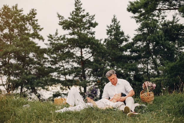 Beautiful adult couple spends time in a summer field