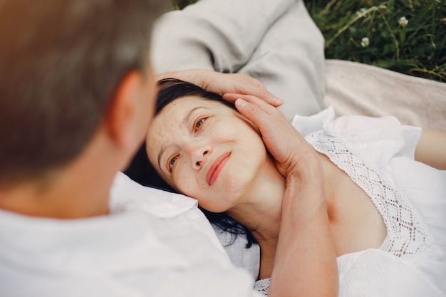 Beautiful adult couple spends time in a summer field