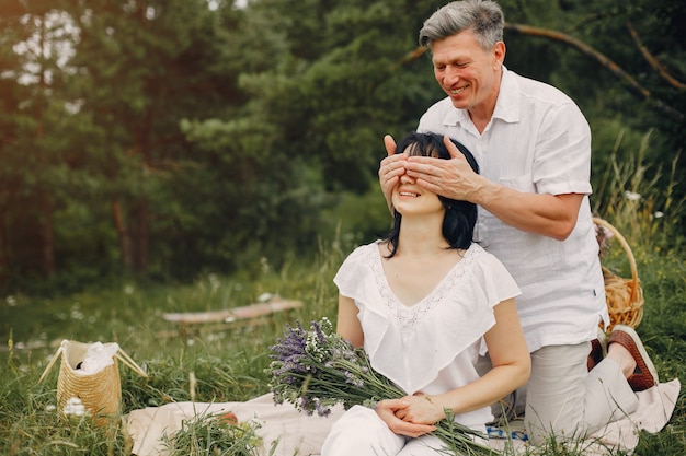 Beautiful adult couple spends time in a summer field