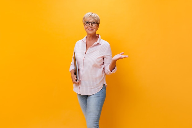 Beautiful adult woman in eyeglasses posing with paper sheets