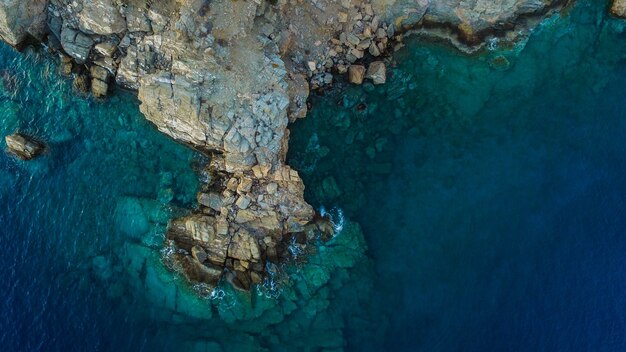 Beautiful aerial drone shot of the sea with rock formations on the shore