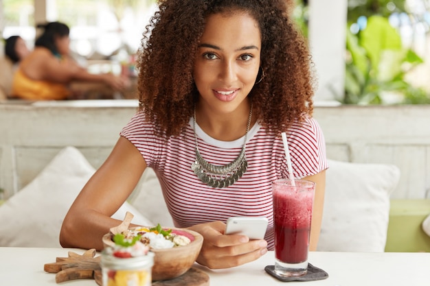 Beautiful African-American woman in cafe