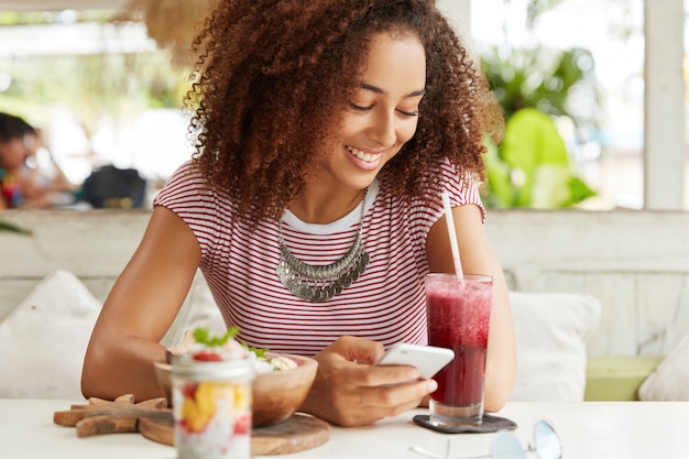 Beautiful African-American woman in cafe