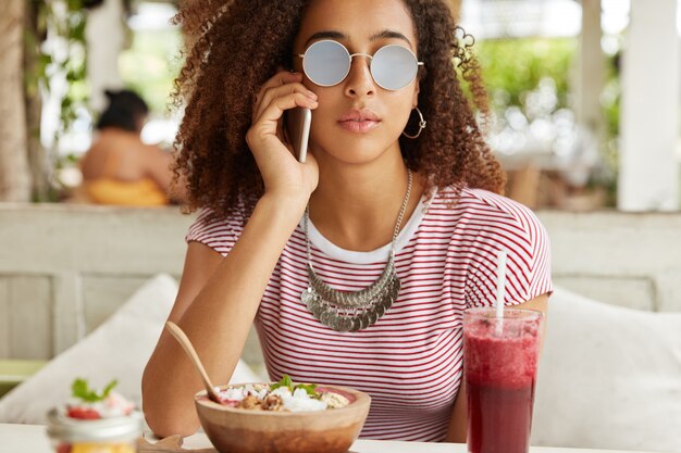 Beautiful African-American woman in cafe