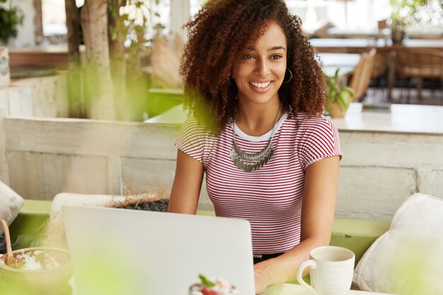 Beautiful African-American woman in cafe