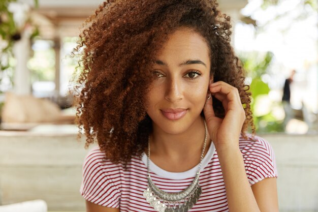 Beautiful African-American woman in cafe