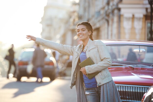 Beautiful african girl catching the car