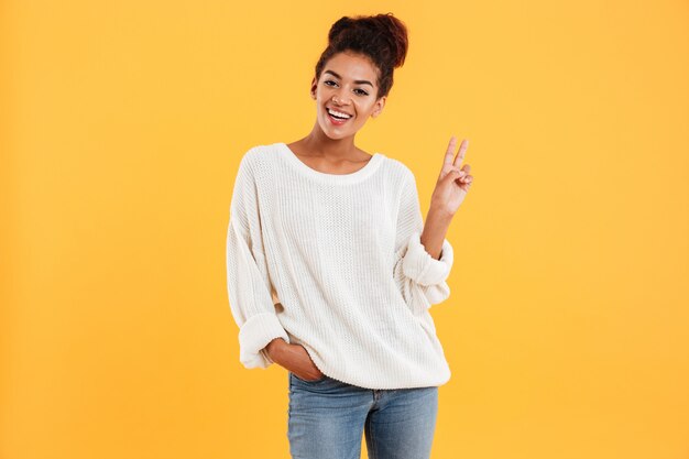 Beautiful african lady showing peace gesture isolated