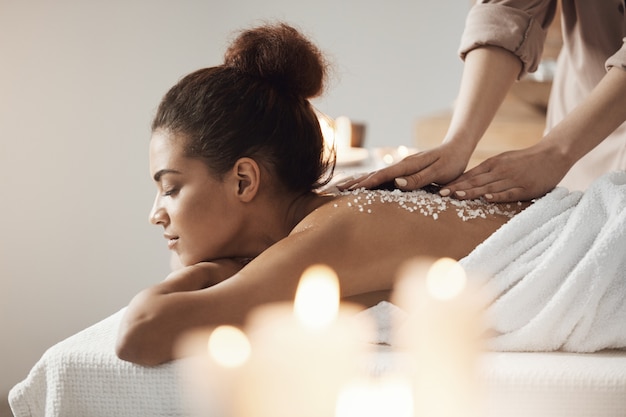 Free photo beautiful african woman resting enjoying spa health massage with sea salt.