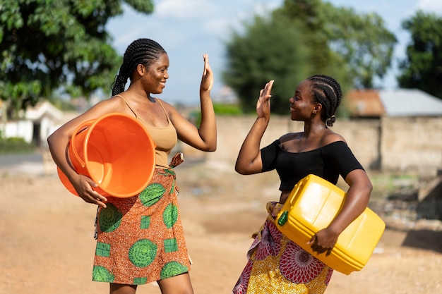 Beautiful african women having fun while fetching water