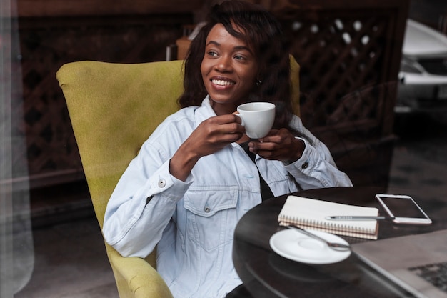 Beautiful afroamerican woman having coffee