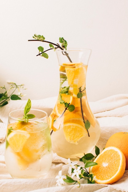 Free photo beautiful arrangement with orange juice in carafe