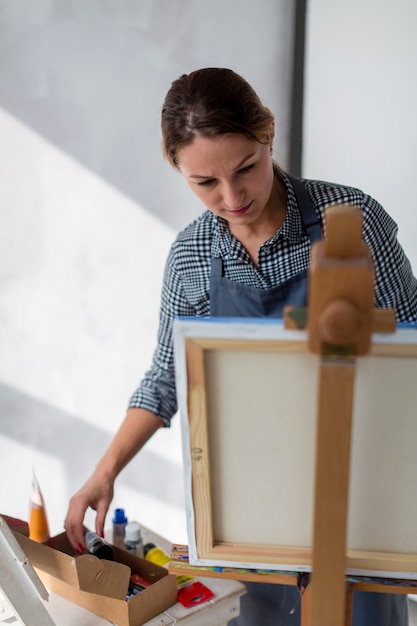 Beautiful artist looking at canvas