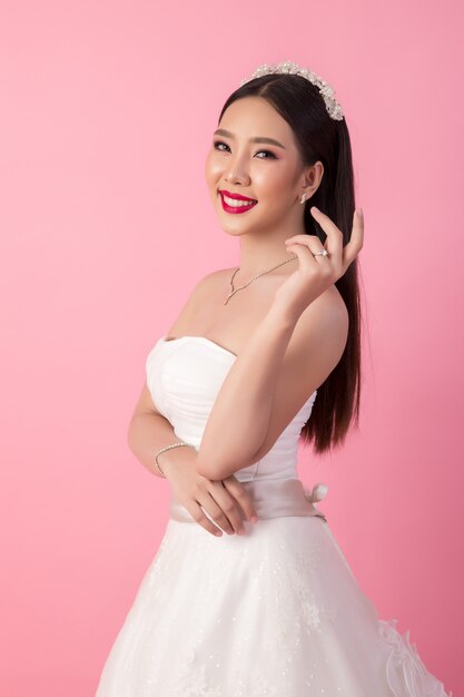 Beautiful asian bride portrait in pink studio