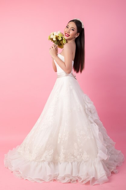 Beautiful asian bride portrait in pink studio