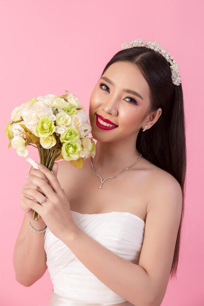 Beautiful asian bride portrait in pink studio