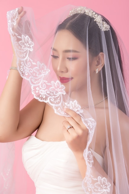 Beautiful asian bride portrait in pink studio