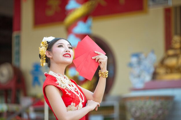 A beautiful asian girl wearing a red dress 