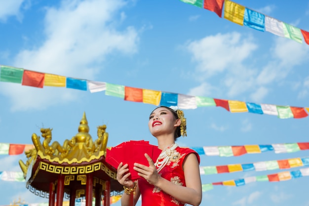 A beautiful asian girl wearing a red dress 